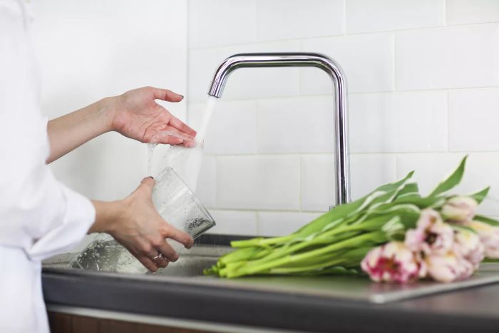 filling flower vase with water