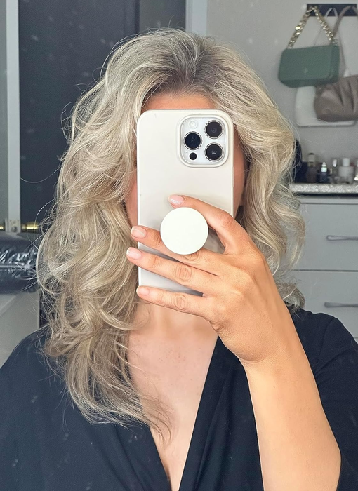 A reviewer with styled, wavy hair