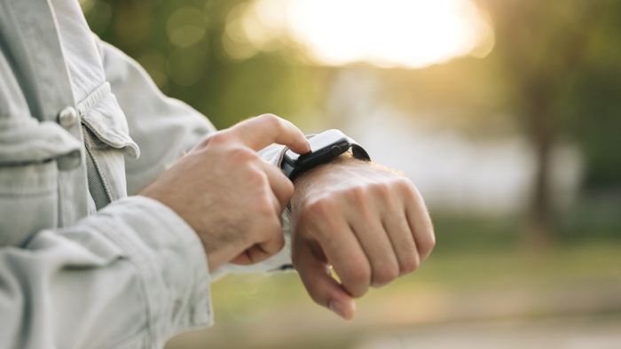 a person wearing a fitness watch on their wrist
