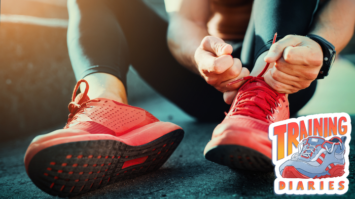 A person getting ready by tying their running shoes