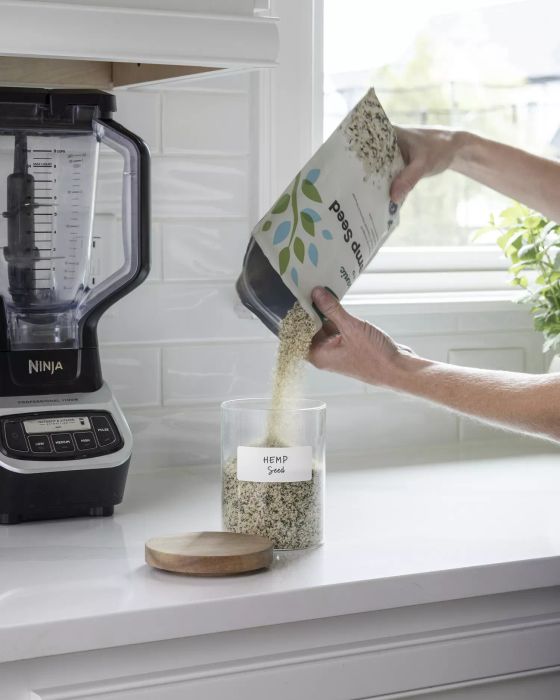 Transferring dried foods into labeled canisters