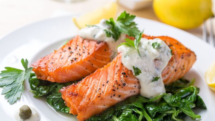 A serving of salmon accompanied by a flavorful sauce