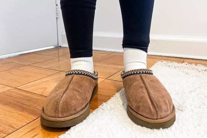A person sporting the Ugg Tasman slippers