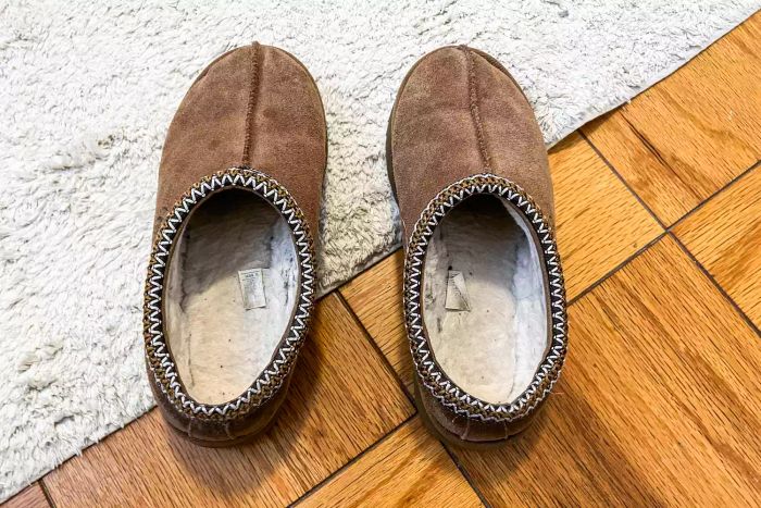 A pair of Ugg Tasman slippers resting on the floor