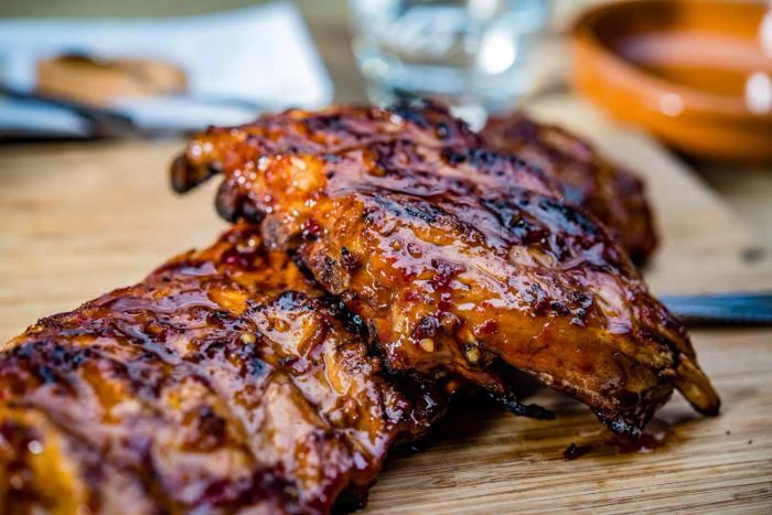 Saucy ribs resting on a cutting board