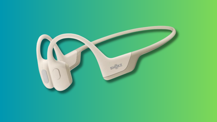 The SHOKZ OpenRun Pro displayed against a vibrant teal and green gradient backdrop.