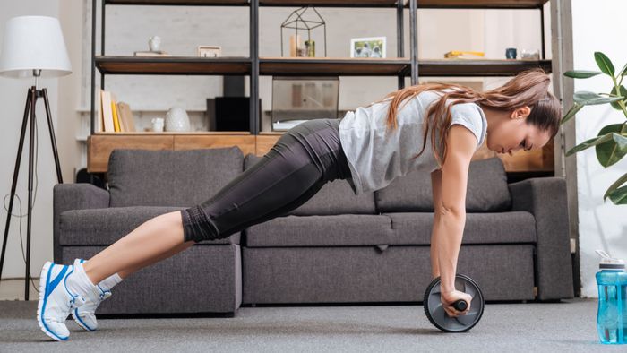 woman performing exercises with an ab wheel