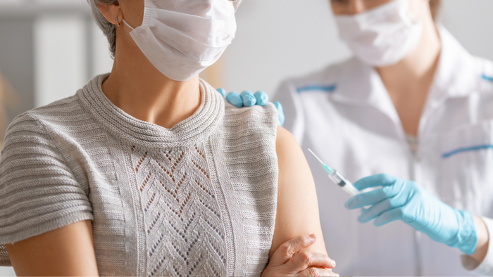 An older individual receiving the RSV vaccine from a healthcare professional