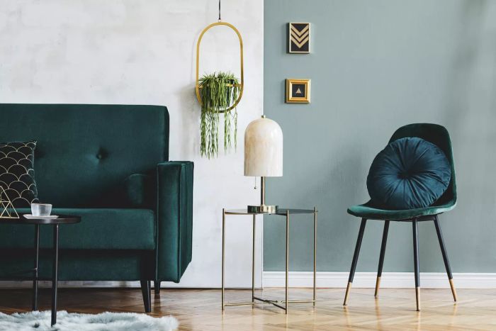 A stylish living room setup featuring a plush green velvet sofa and sophisticated accessories. Contemporary home design inspiration. Template.