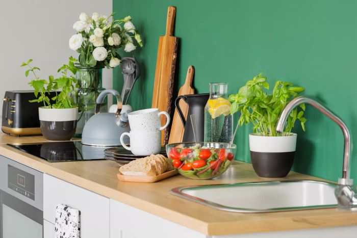 A trendy kitchen featuring bread and a vegetable salad on a wooden countertop