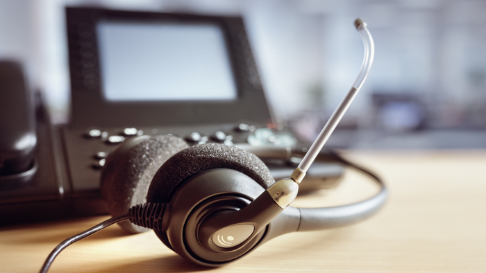 customer service representative with headset and phone