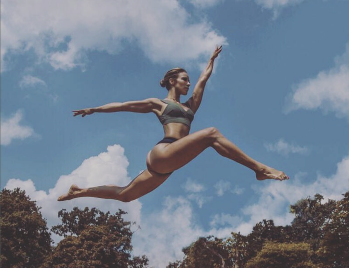 Marlyn Ortiz jumps into the air with energy.