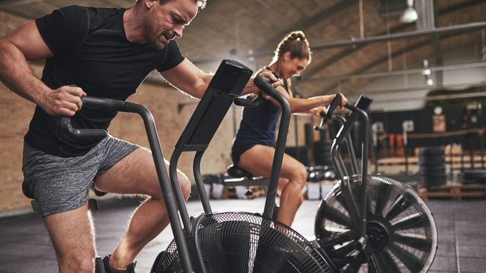 individuals using stationary bikes for exercise