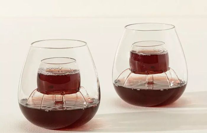 a pair of stemless wine glasses equipped with an aerating system