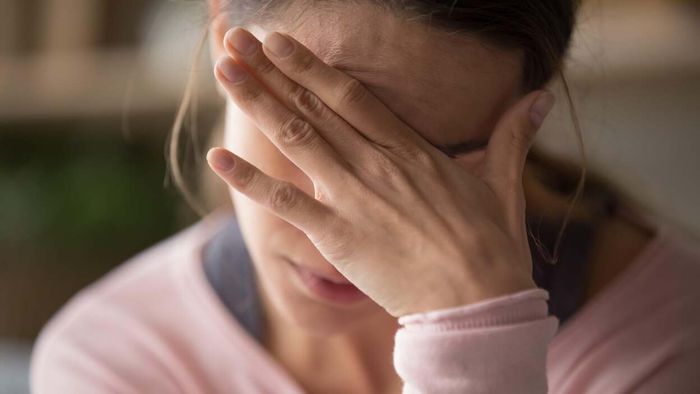Woman experiencing pain due to a migraine