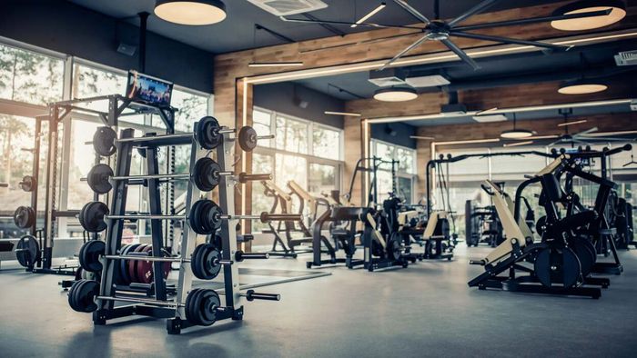 A well-equipped modern gym environment filled with various fitness machines.