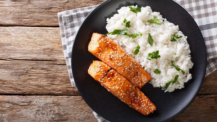 a plate of salmon paired with rice