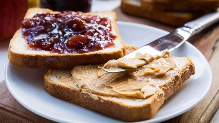 A classic peanut butter and jelly sandwich served on a plate