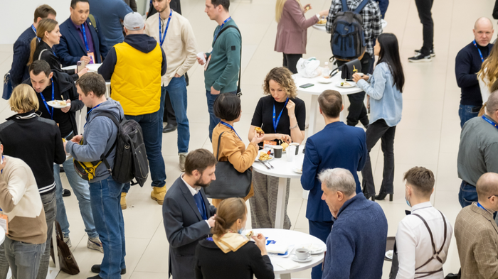 A group of individuals gathered around tables during a networking event