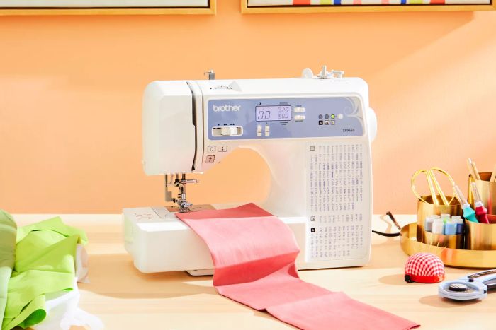 The Brother XR9550 placed on a table surrounded by fabric.