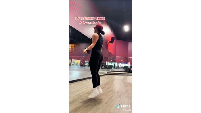 A woman jumping rope with text: 