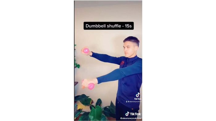 A man holding tiny pink dumbbells
