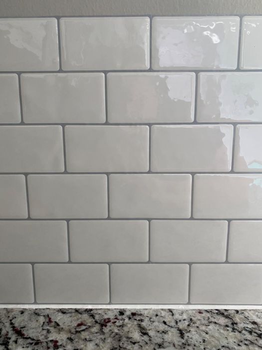 A close-up view of the crisp white subway tiles.