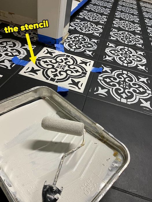 A reviewer applying the stencil to their floor.