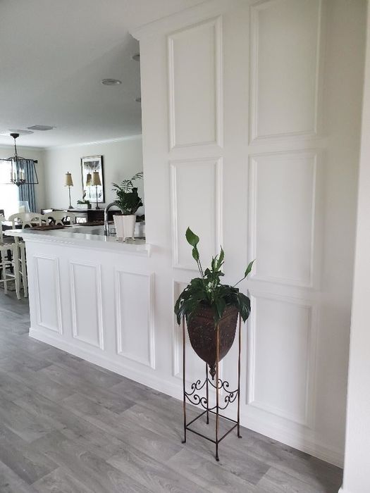 A reviewer’s wall featuring panels installed and painted white, adding depth to the space.