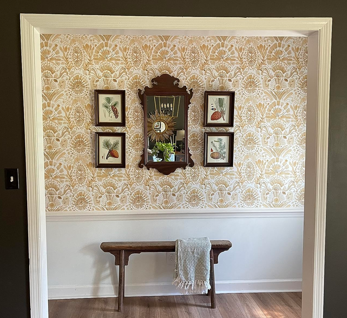 A reviewer's foyer featuring vibrant yellow damask wallpaper.