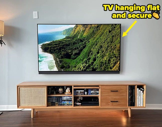 A reviewer's TV mounted seamlessly on the wall, looking sleek and modern.