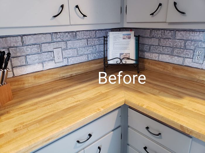 A reviewer’s before photo showing a kitchen without lighting.