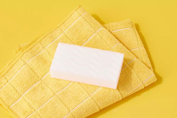 Magic eraser and yellow microfiber towel