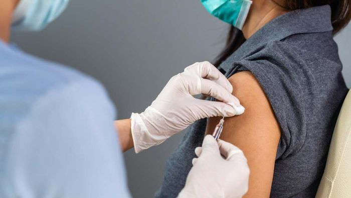 A woman being administered a COVID vaccine