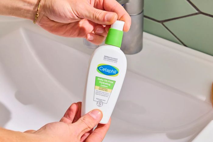 A person holding the Cetaphil Daily Oil Free Hydrating Lotion with Hyaluronic Acid