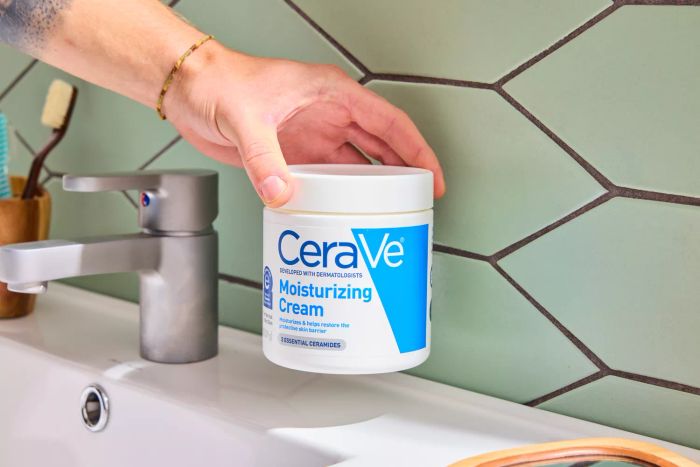 A person holding the CeraVe Moisturizing Cream