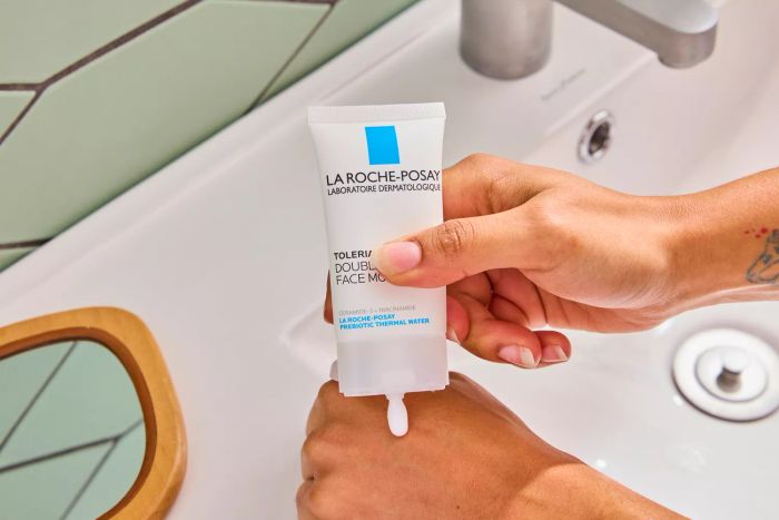 A person applying the La Roche-Posay Toleriane Double Repair Face Moisturizer to the back of their hand