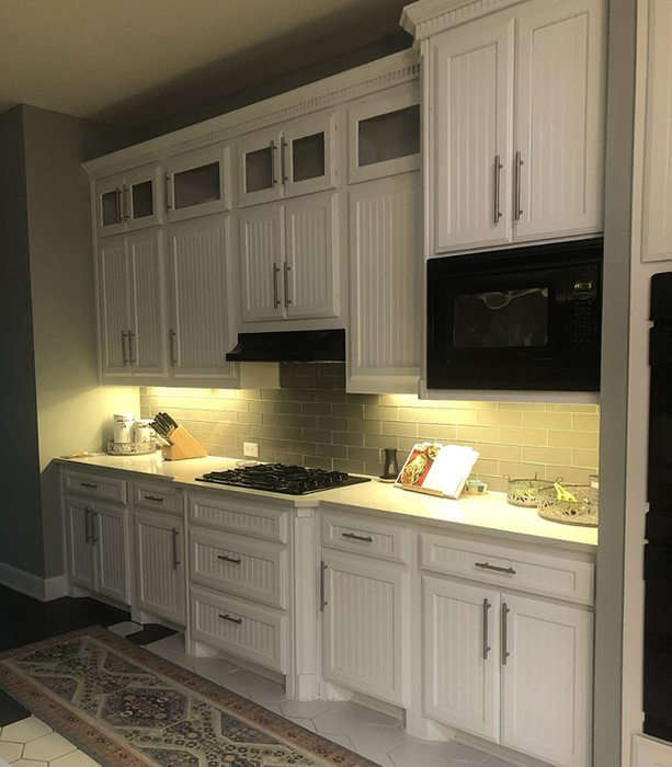 A kitchen with under-cabinet lights brightening the countertops