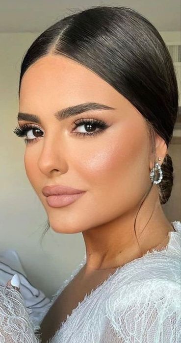 A reviewer showcasing their flawless makeup look using the concealer