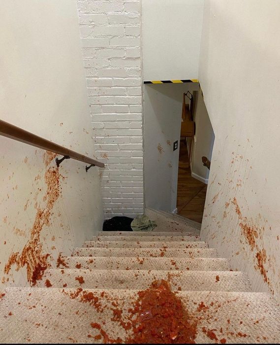 Red salsa spilled all over carpeted stairs