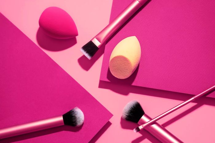 A collection of versatile makeup brushes set against the vibrant Viva Magenta and soft pastel Pink, the 2023 Color of the Year. Featuring essential tools like foundation brushes, beauty blenders, and applicators for powder, eyeshadow, concealer, blush, and highlighter. Perfect for creating flawless looks with the trending Viva Magenta theme.