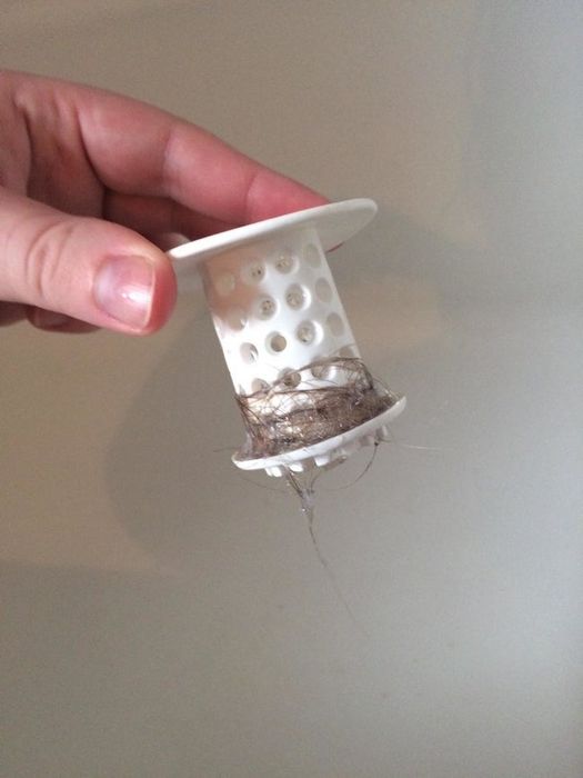 Hair wrapped around a cylindrical white silicone TubShroom