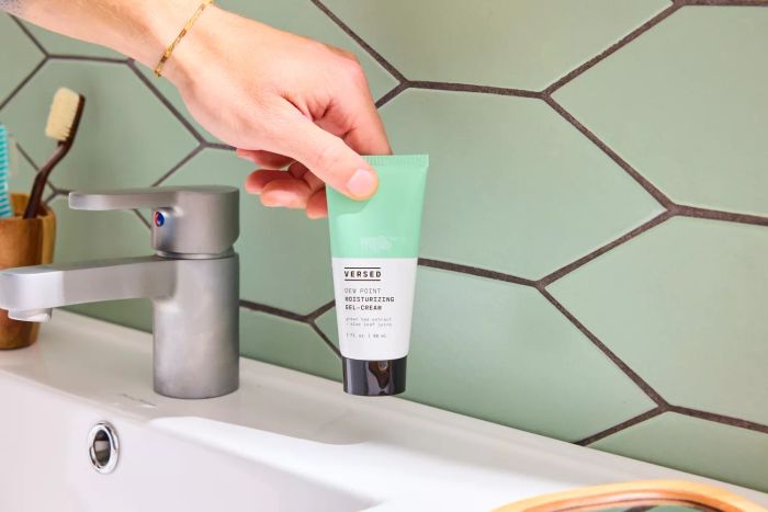 A person holding the Versed Dew Point Moisturizing Gel-Cream