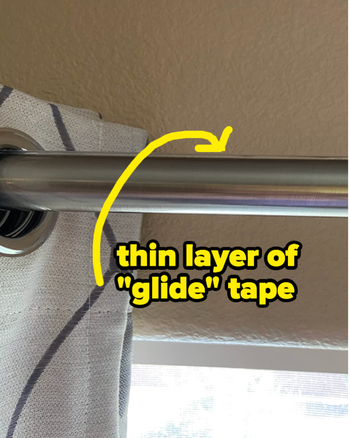 A curtain rod with a thin layer of glide tape applied to the top
