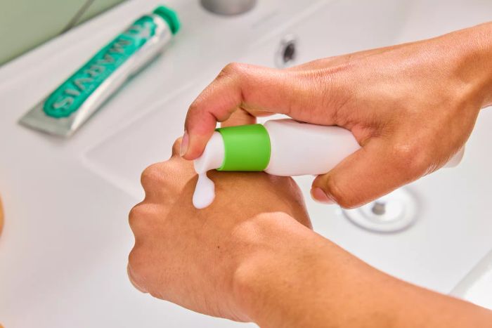 A person applying the Cetaphil Daily Oil Free Hydrating Lotion with Hyaluronic Acid to the back of their hand