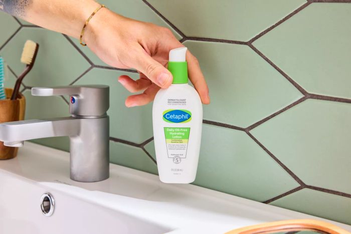 A person holding the Cetaphil Daily Oil Free Hydrating Lotion with Hyaluronic Acid