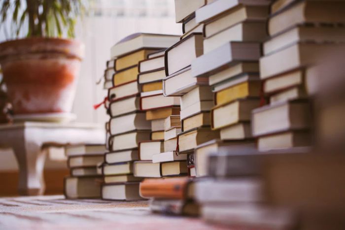 piles of books scattered on the floor