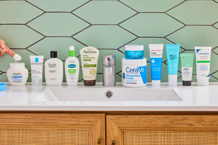 A collection of recommended drugstore moisturizers displayed on a sink