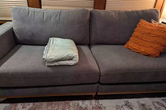 The Aricove Cooling Weighted Blanket neatly folded on a couch
