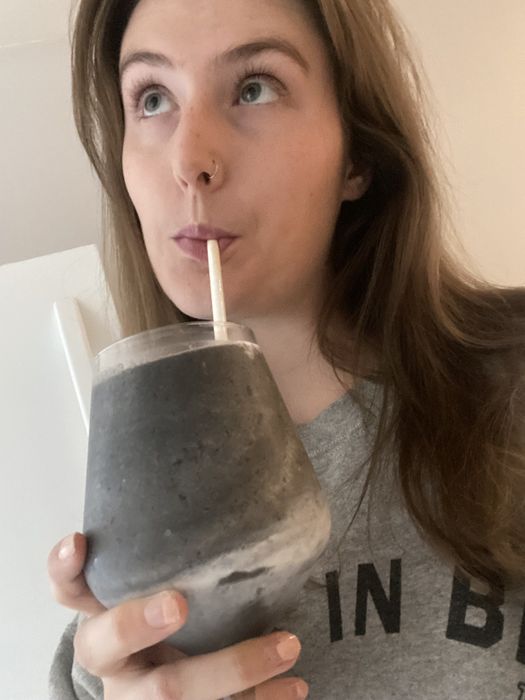 The author drinking her smoothie